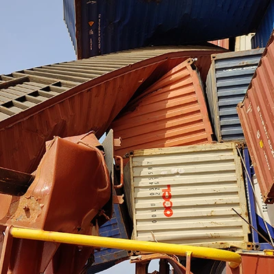 Shipping containers which have been partially crushed. 
